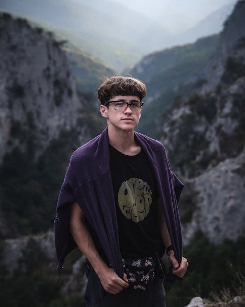 Young Man on the Background of a Mountain Landscape 