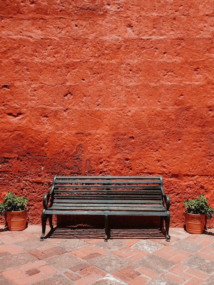 Bench, Potted Flowers On The Red Wall