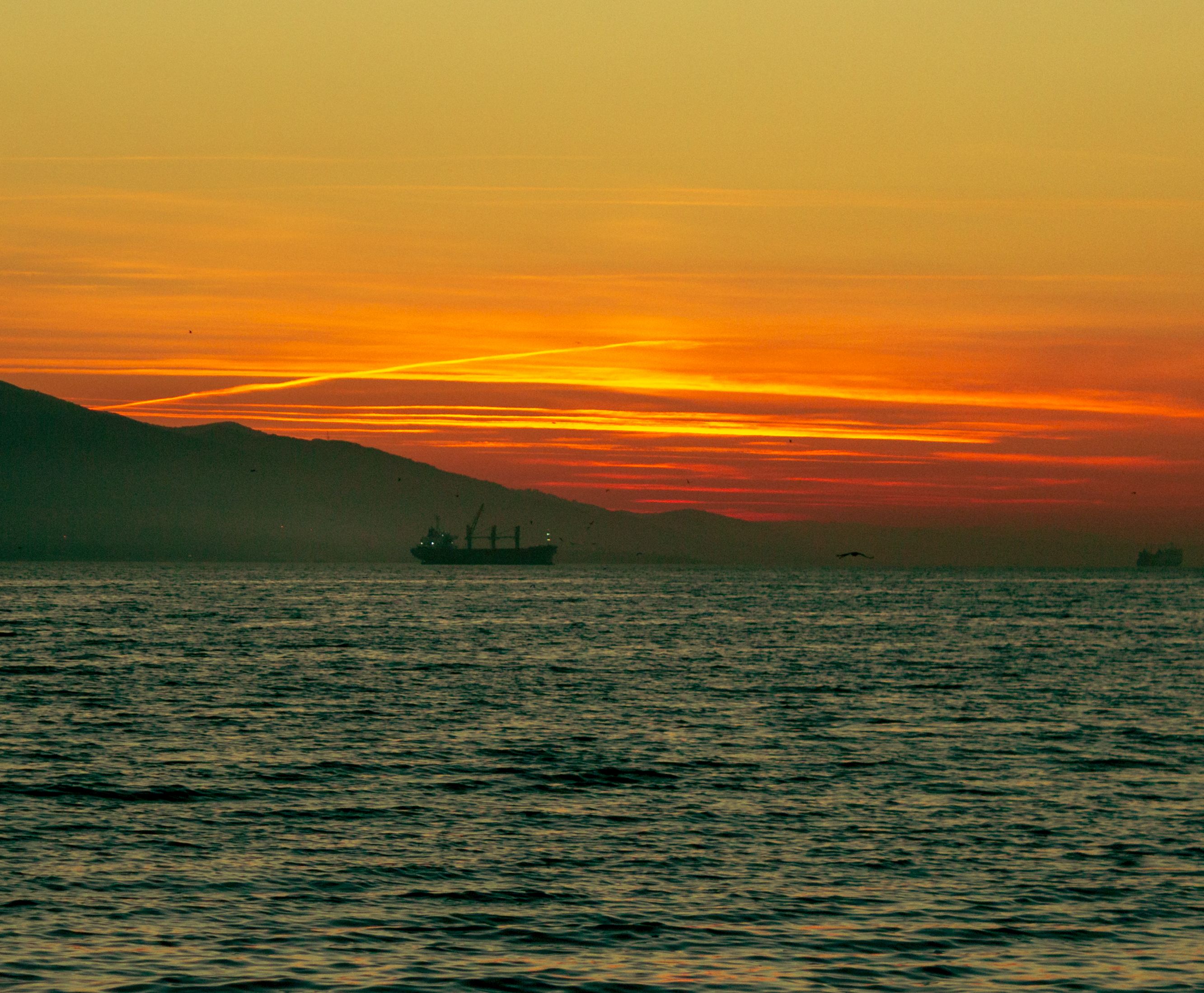 Ship at Sea under a Dramatic Sky at Sunset · Free Stock Photo