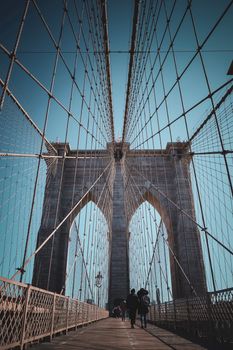 Brooklyn Bridge under a clear sky, showcasing iconic architecture and urban design.