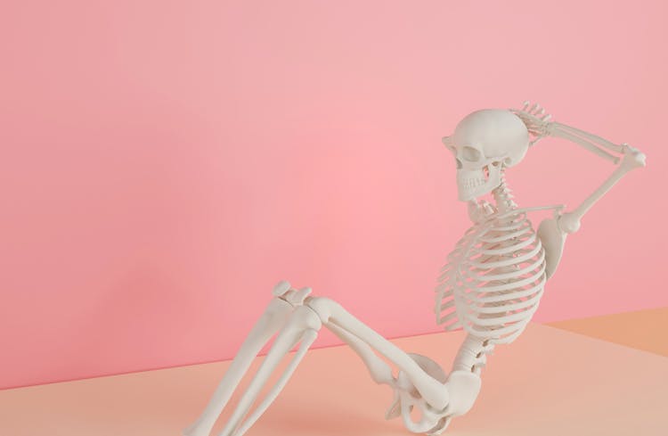 Person Skeleton Stretching In Pink Studio