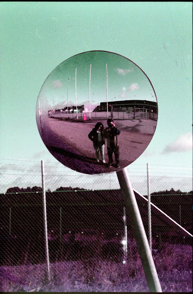 Couple Taking Picture In Road Mirror