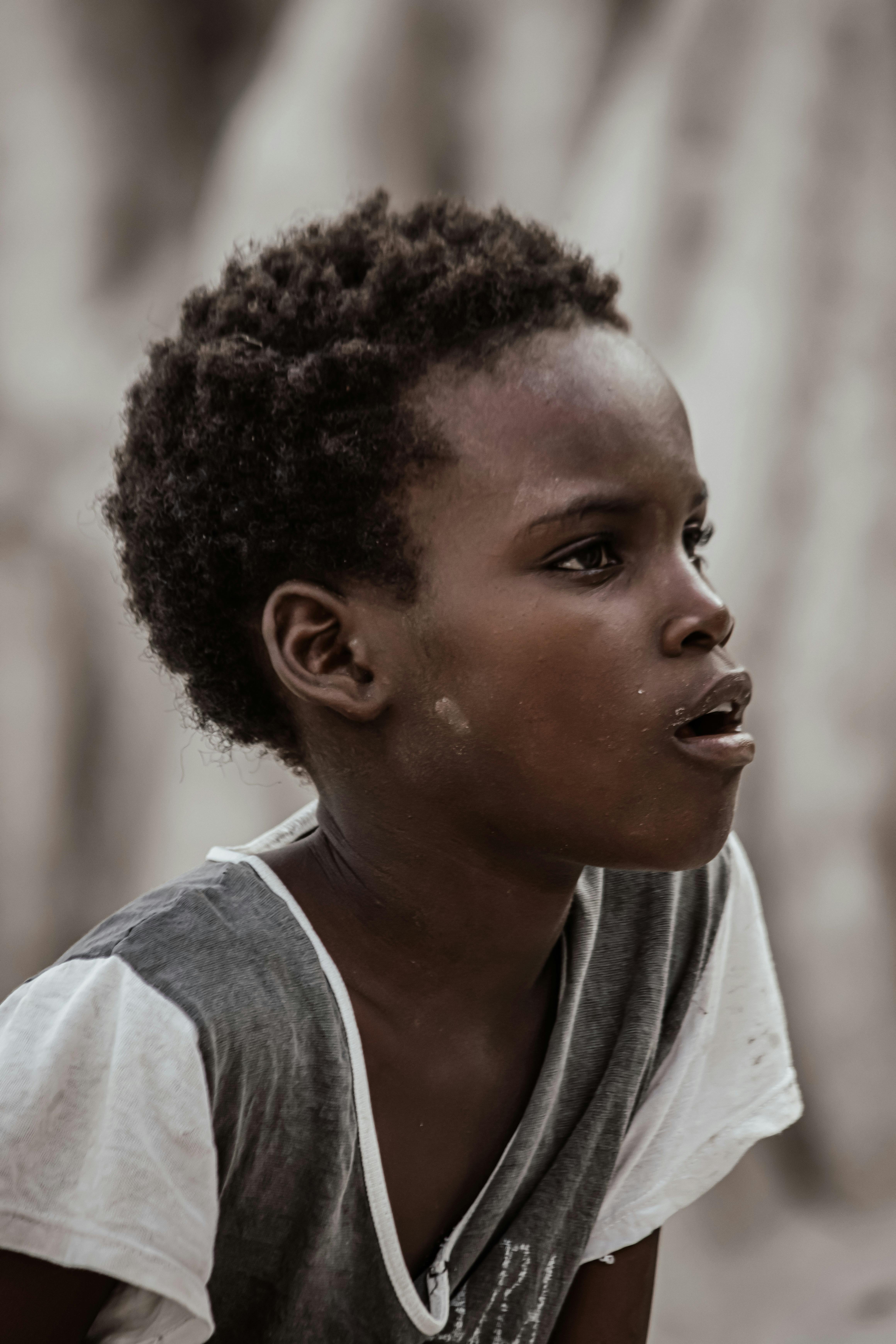 a young african boy with a funny look on his face