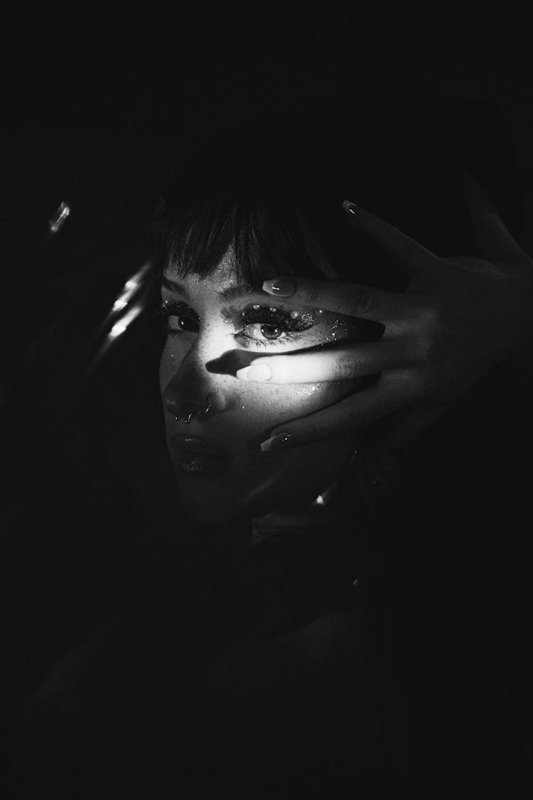 Womans Illuminated Face In The Dark