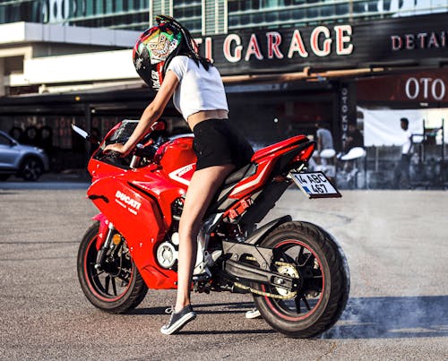 Sexy Woman in Helmet Sitting on Motorbike