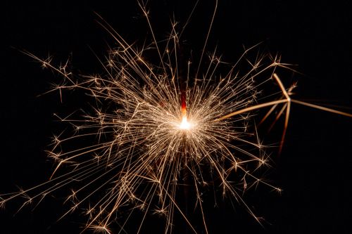 Free A bright sparkler illuminates the night, perfect for celebrations or festive themes. Stock Photo