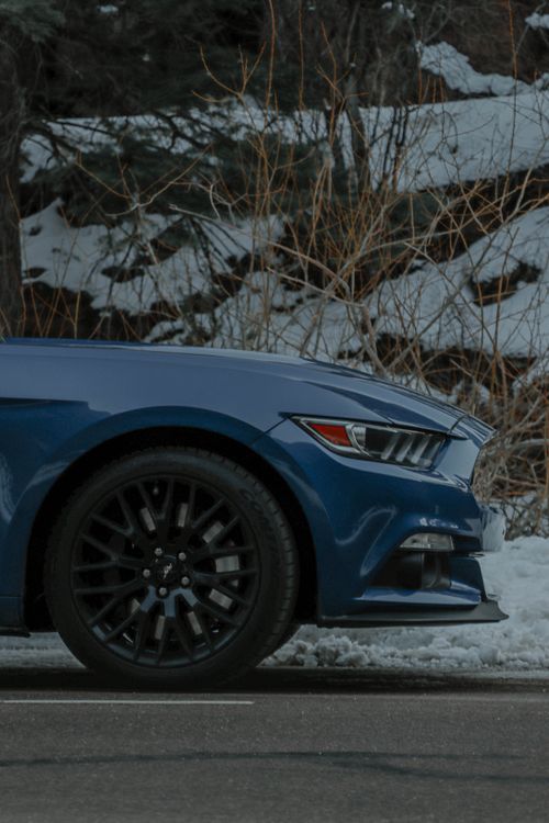 Free Close-up of a blue sports car on a snowy road in Colorado Springs. Stock Photo
