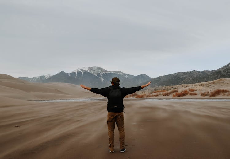 Man Hiking On Desert