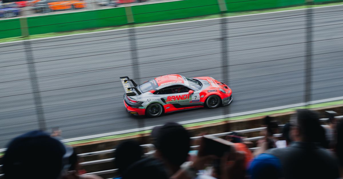 Crowd on Stand and Racing Car on Circuit · Free Stock Photo