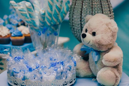 Charming setup for a baby shower with blue decorations and treats.