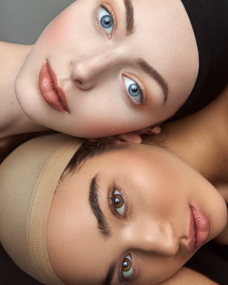 Portrait Of Women Wearing Caps Over Hair