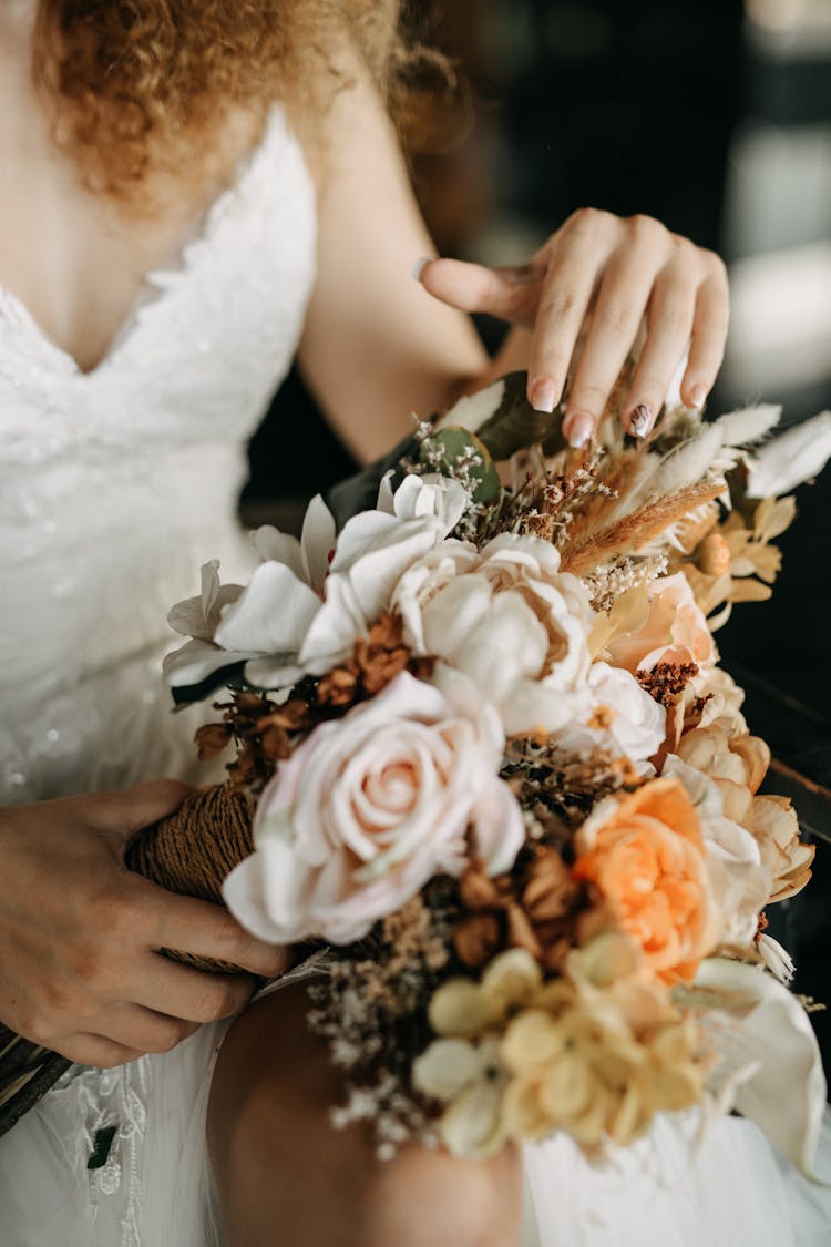 Woman Hands On Flowers Bouquet