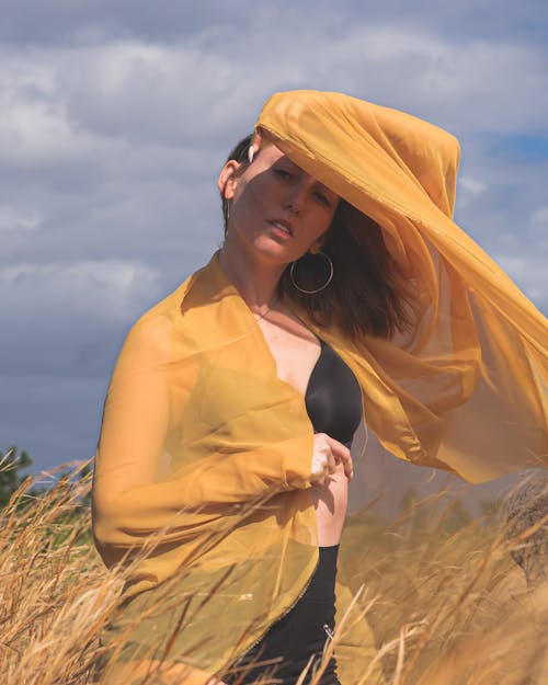 Woman Posing under Yellow Veil