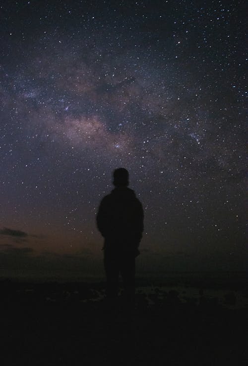 Silhouette of Person Against Night Sky