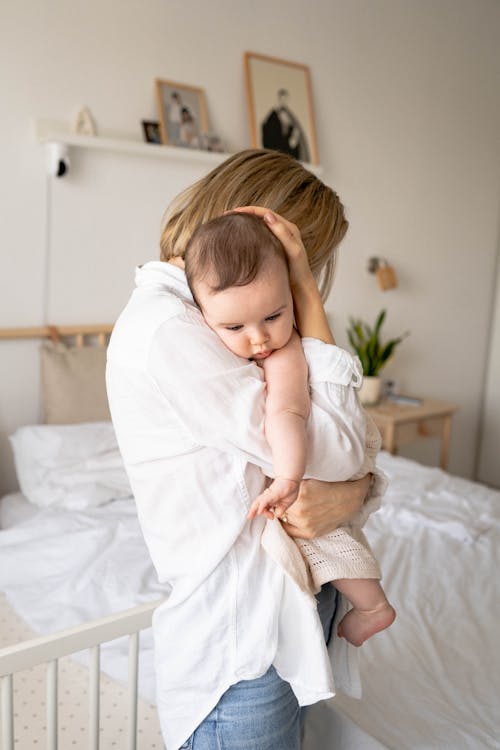 Mother Holding and Hugging Her Baby 