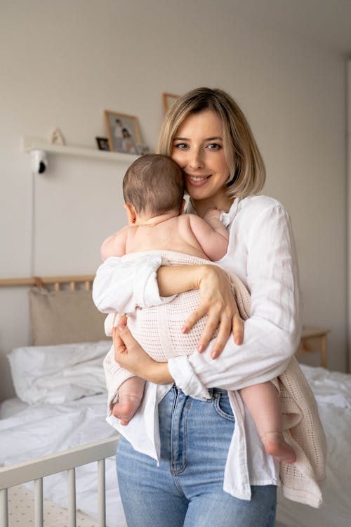 Mother Holding and Hugging Her Baby 