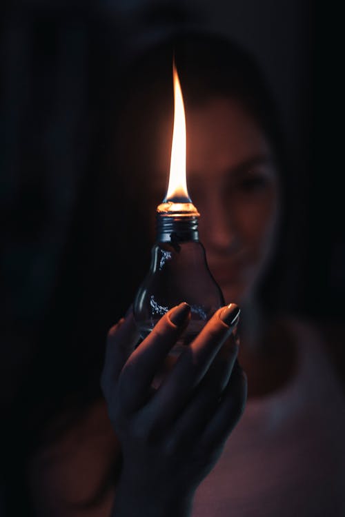 Free Woman Holding Lighted Oil Lamp Stock Photo