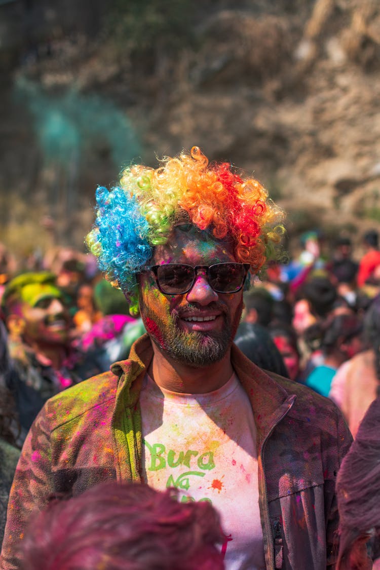 Man With Colorful Wig And Painted Face And Clothes