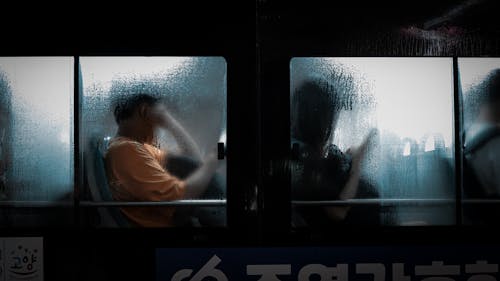 People Sitting in a Bus During Rain 