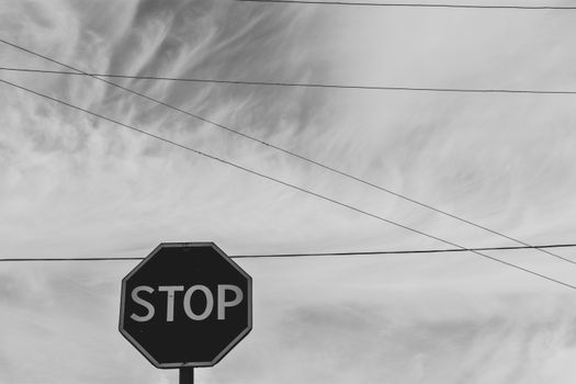 Grayscale Photography of Stop Signage Under Sky