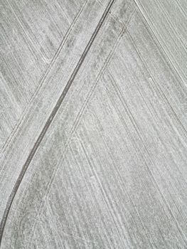 Stunning aerial photo of snow-dusted fields with geometric patterns and tracks visible.