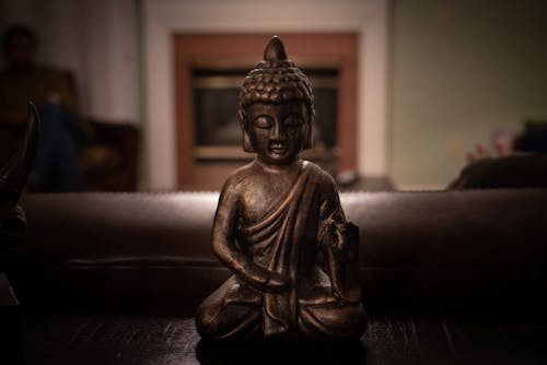 Free Brass Buddha Figurine on Black Surface Stock Photo