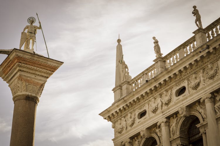 Sculptures And Column Around St Marks Basilica In Venice 