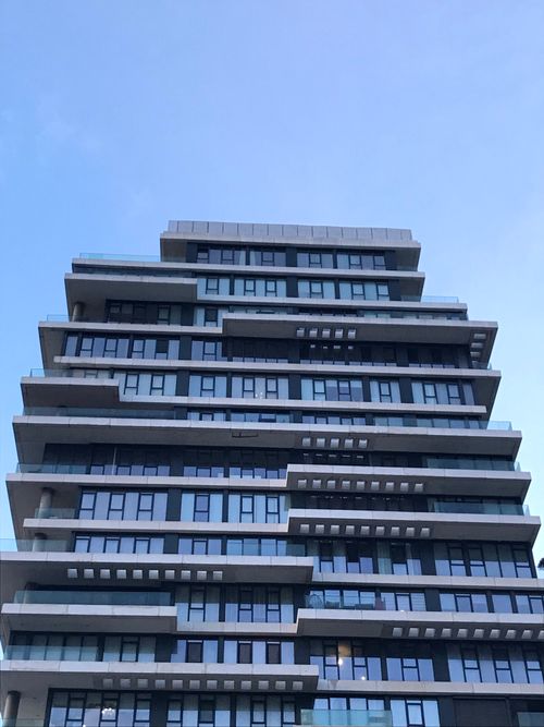 Free Low angle view of a modern architectural office facade against a clear sky. Stock Photo
