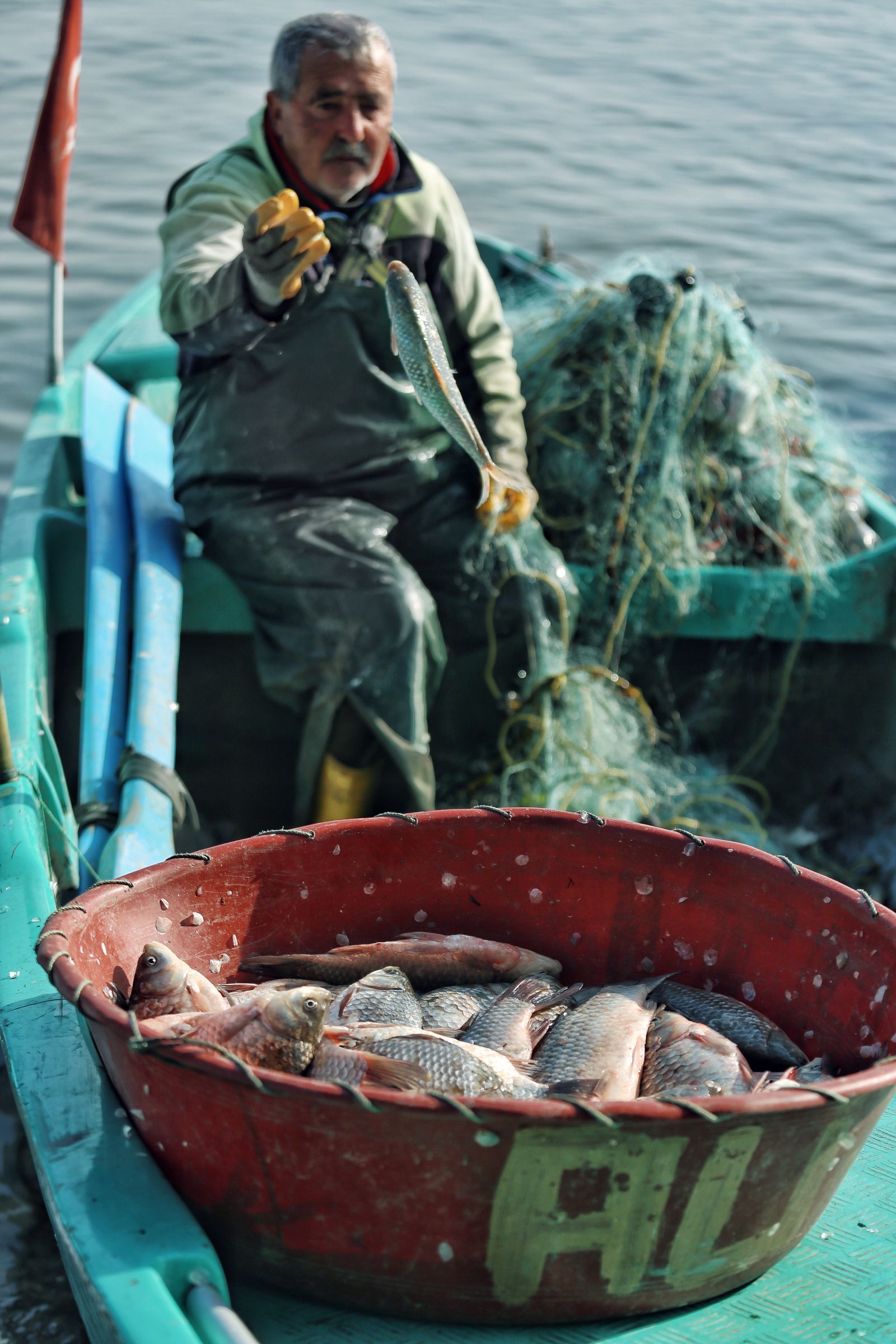 Angler holding a freshly caught fish aboard a charter boat