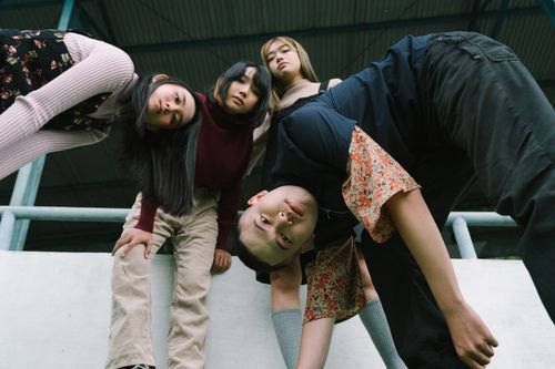 Free Low-angle shot of stylish teenagers posing in a city setting. Stock Photo
