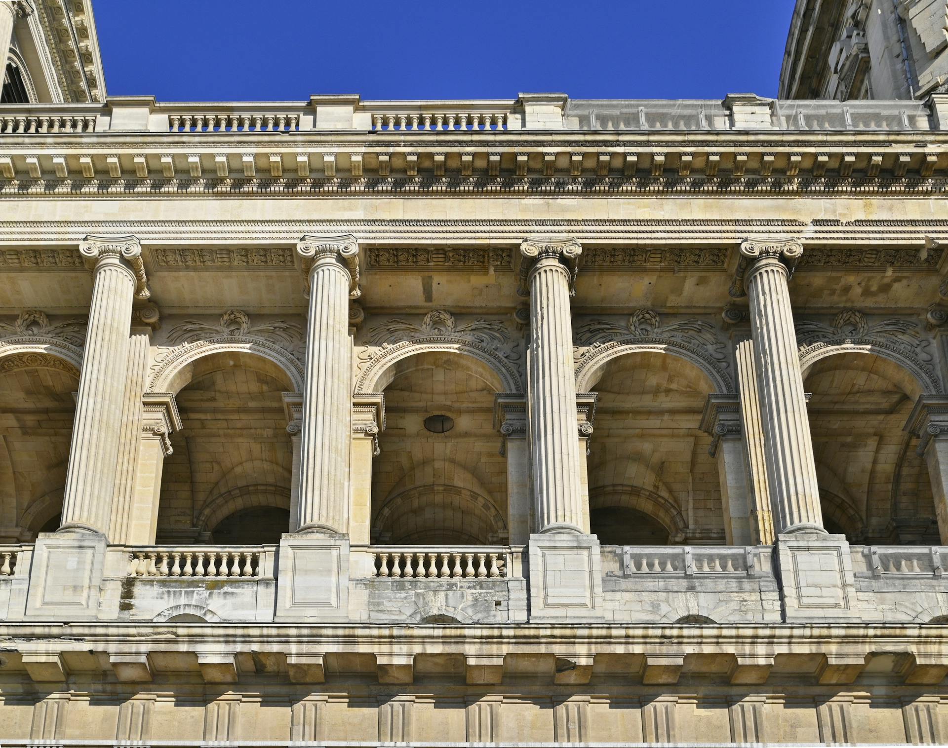 Paris France Roman Catholic Church of Saint Sulpice - Baroque archway, arch, colonnade and ionic columns details closeup from facade