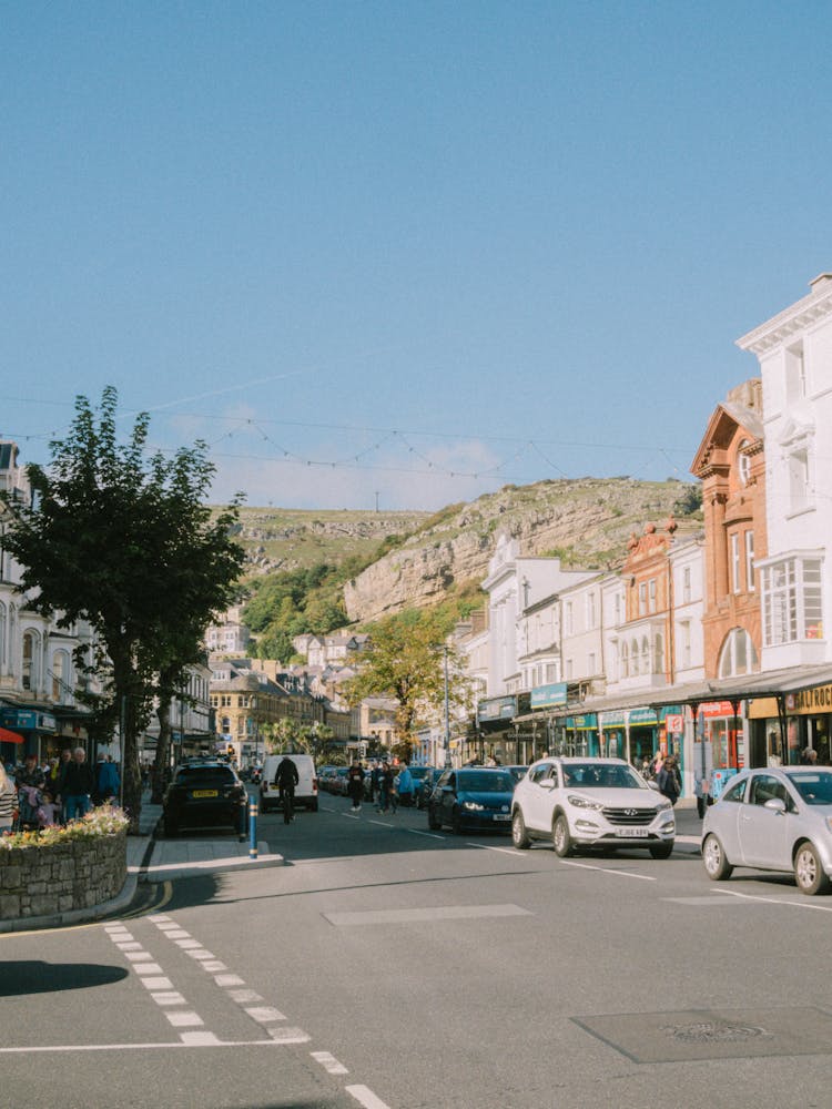 Cars Driving On Street In City In Mountains Landscape