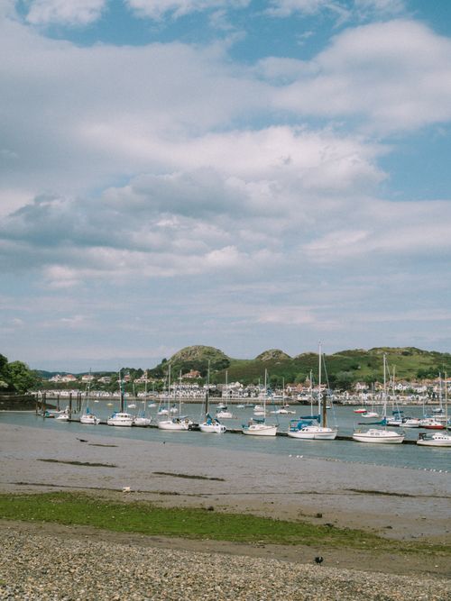Free Picturesque scene of yachts in Conwy Harbor, North Wales, under a bright sky. Stock Photo