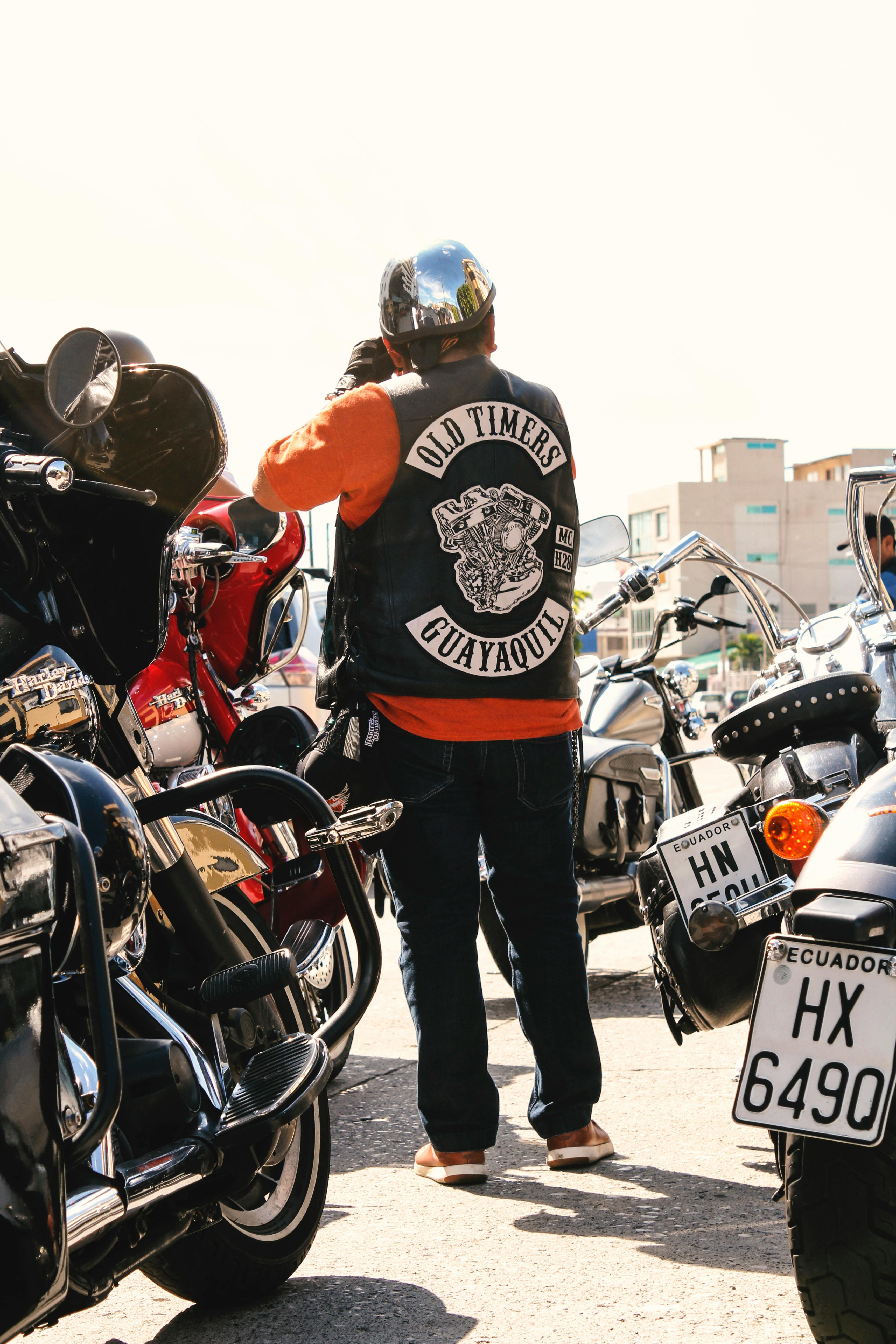 man standing surrounded by motorcycles