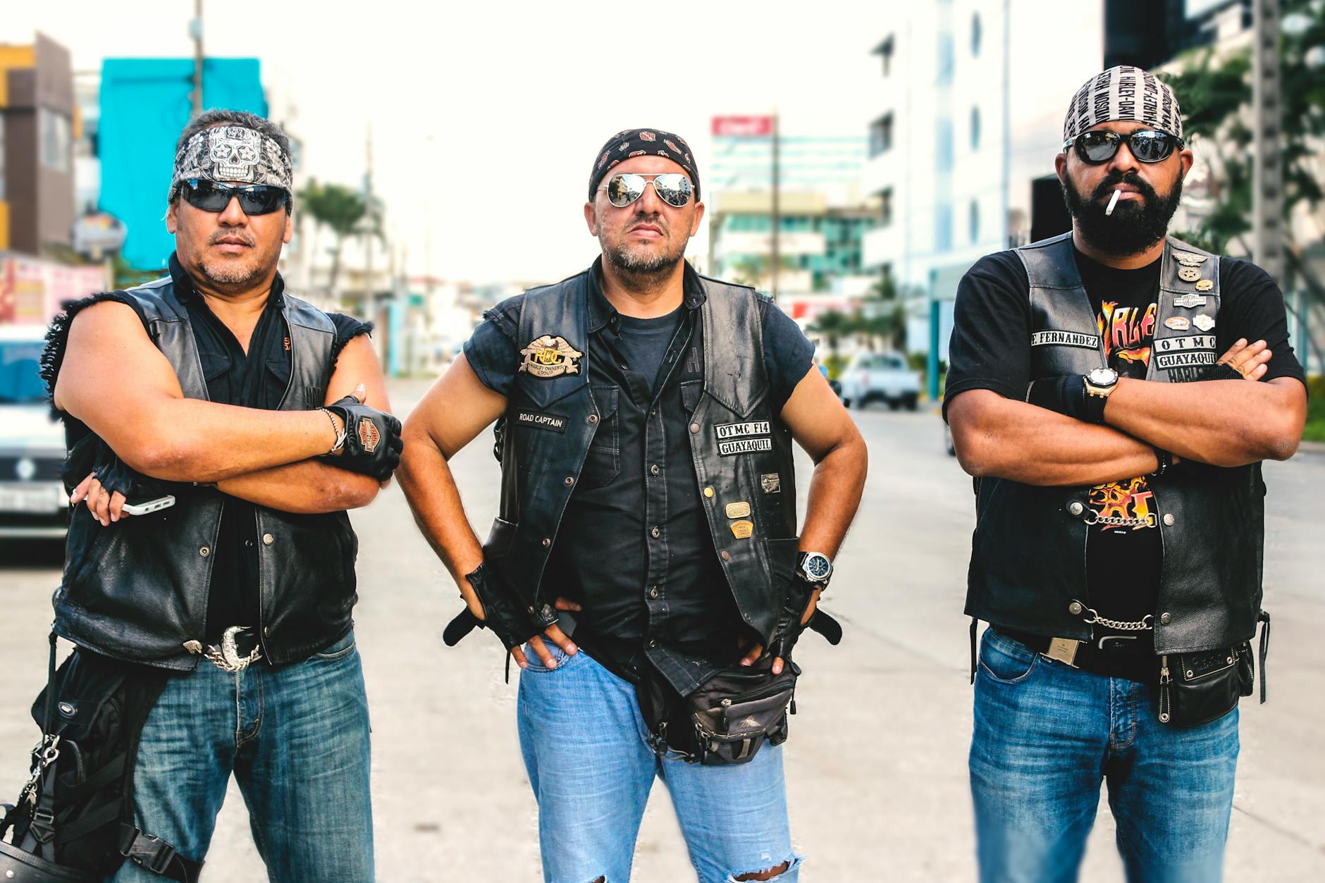 Three Person Wearing Black Leather Vest