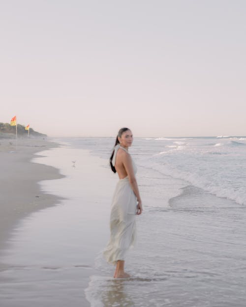 Woman Standing Barefoot at Beach