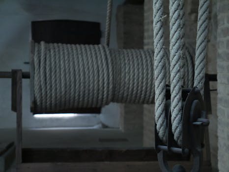 Detailed shot of ropes on a reel indoors, showcasing industrial texture and design.