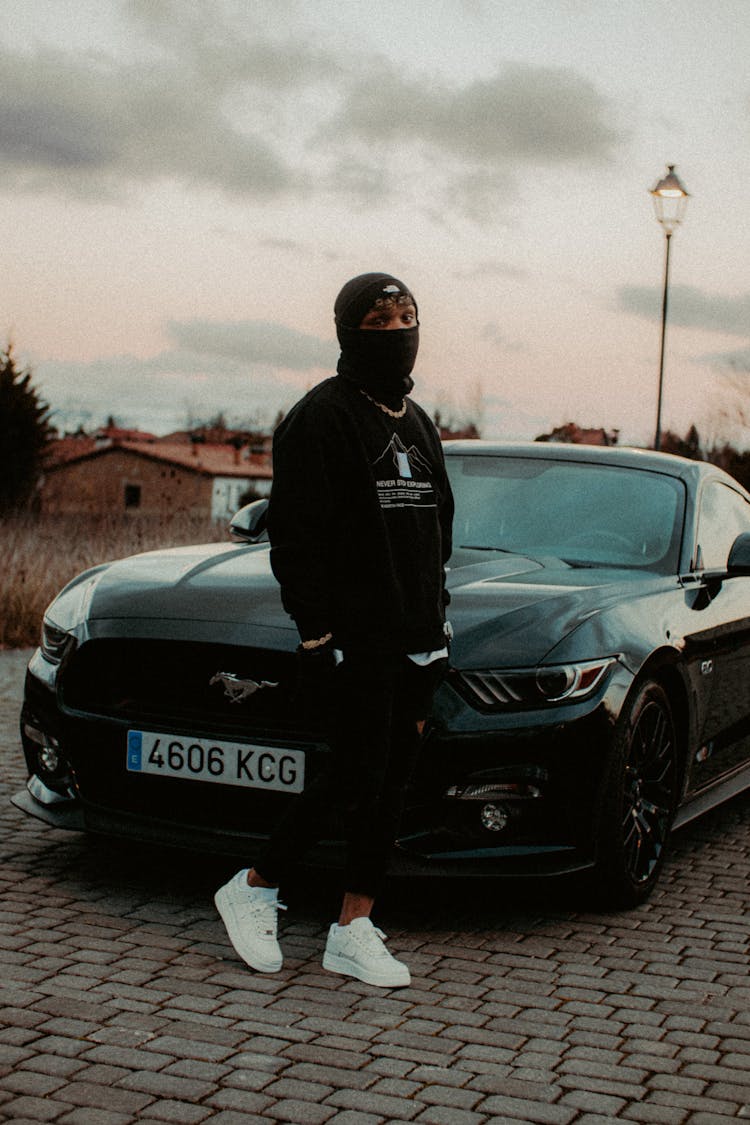 Man In Black Clothes Standing With Ford Mustang