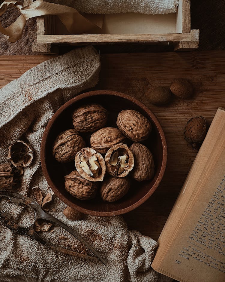 Bowl Of Walnuts By Old Book