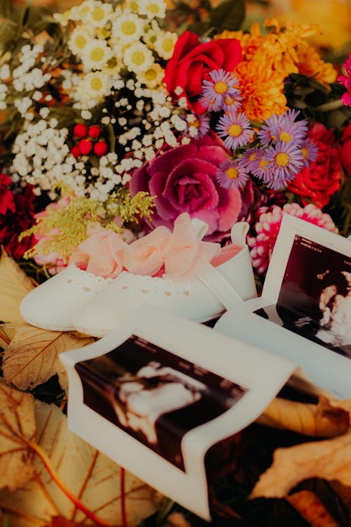 Flowers and Pictures around Baby Shoes