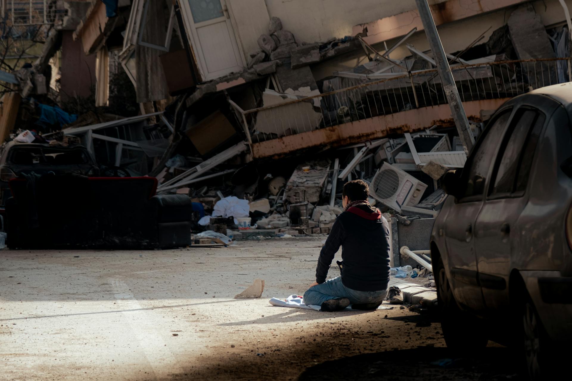Man Sitting on Street after Earthquake