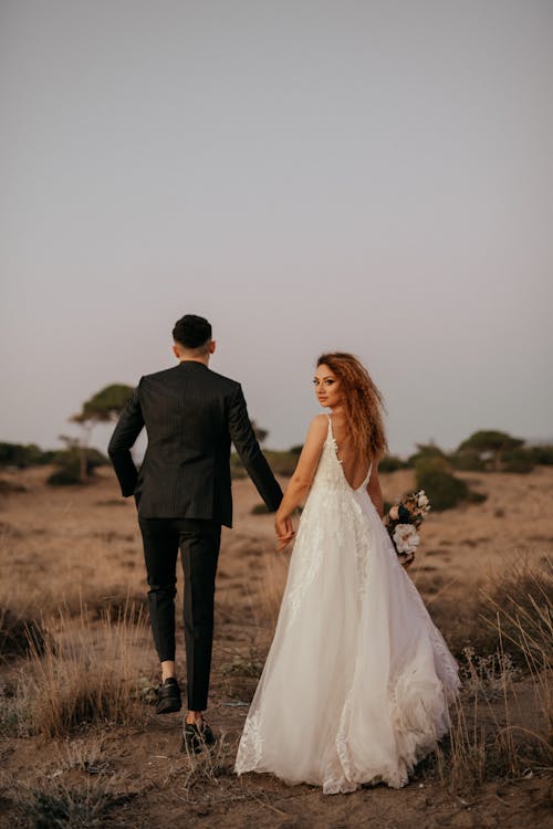 Back View of Newlyweds on Grassland