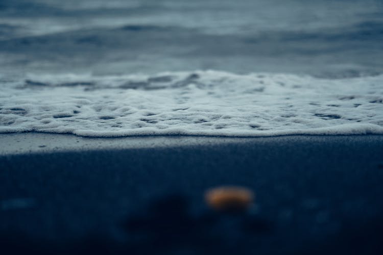 Close Up Of Water Foam On Shore