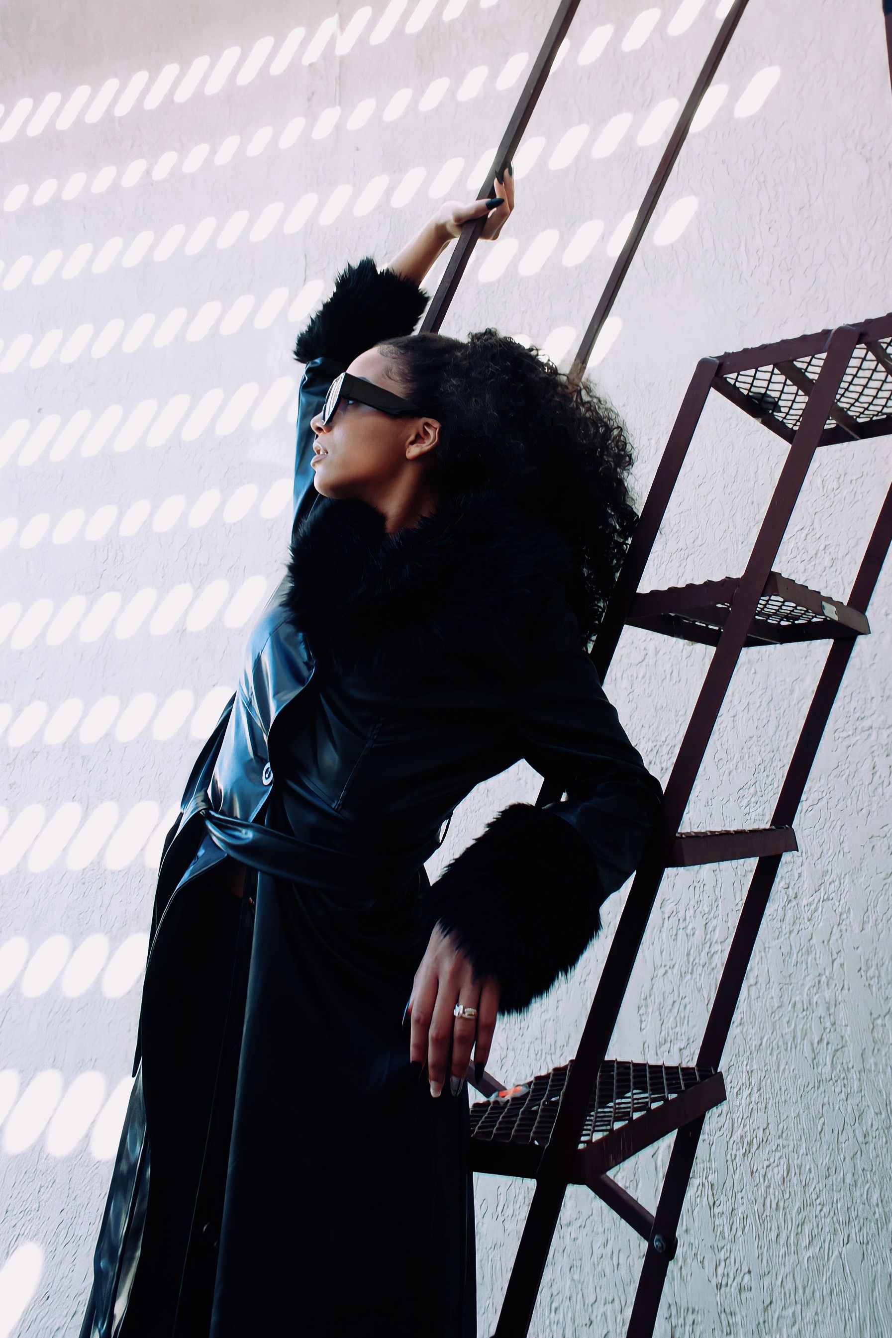 Young Woman Posing in a Black Coat and Sunglasses · Free Stock Photo