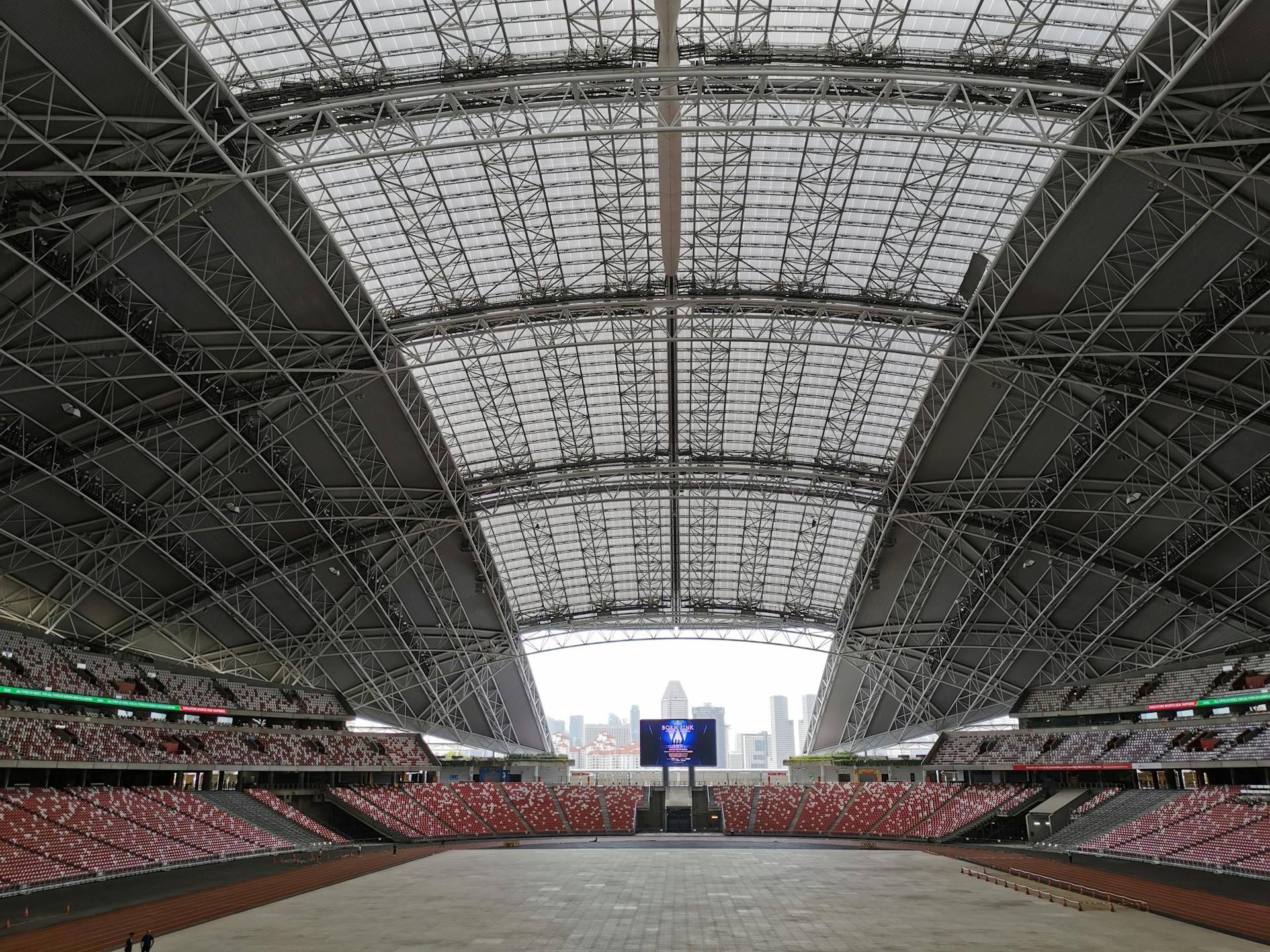 Expansive interior of the Singapore National Stadium with modern architecture.