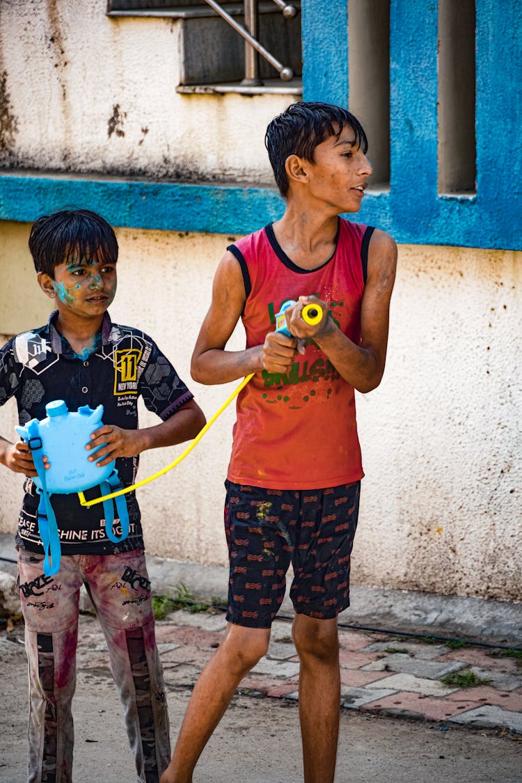 Boys Playing With Toy On Town Street