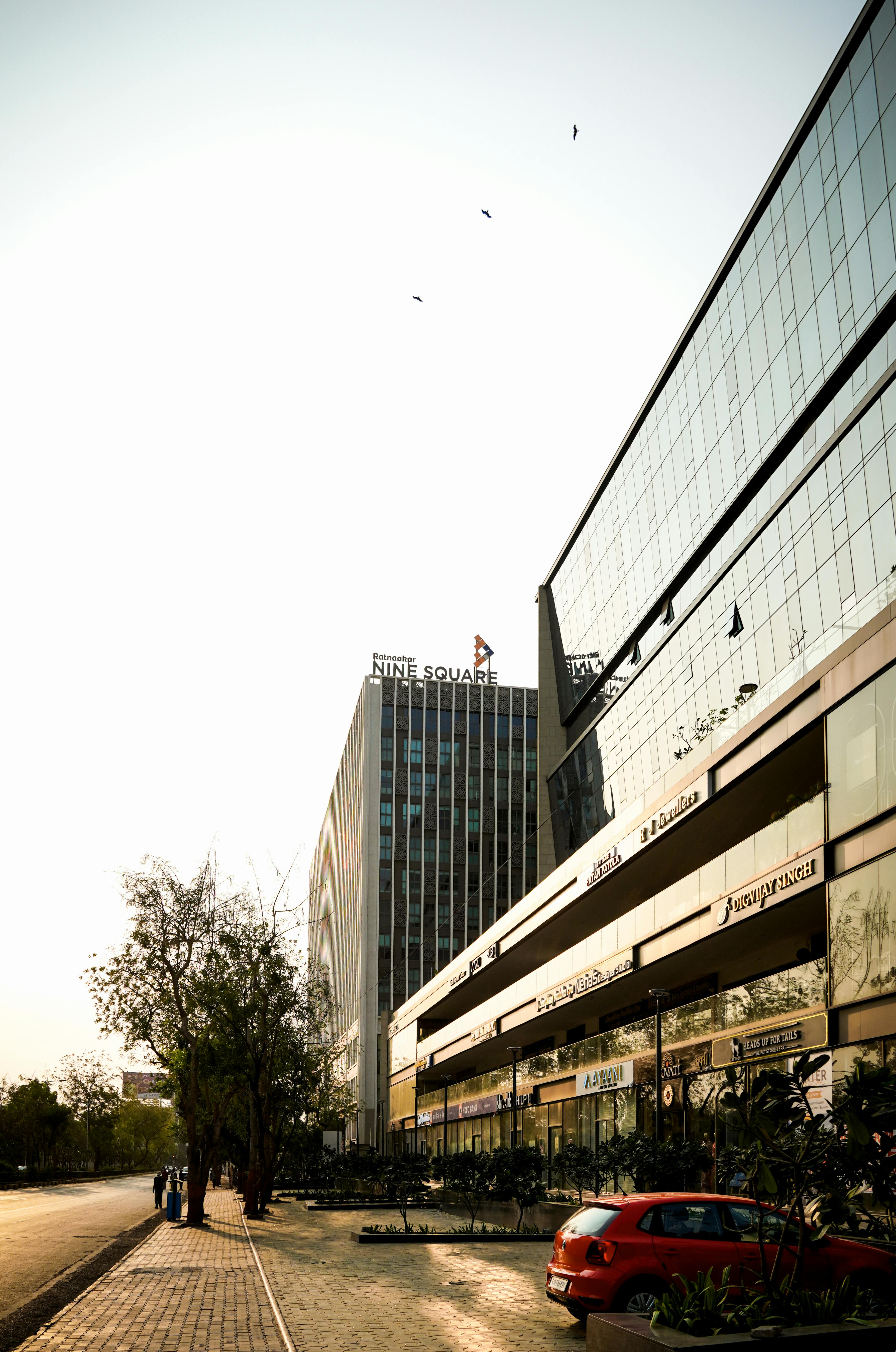 Stunning shot of modern office buildings in Ahmedabad at sunset with a bright sky.