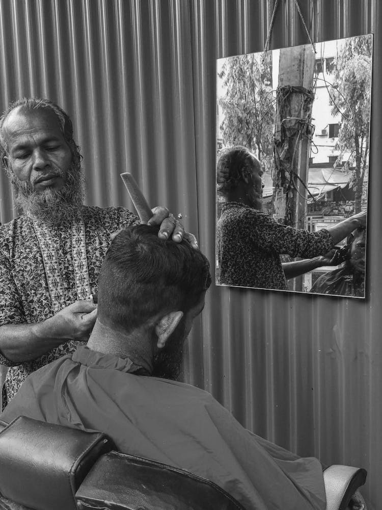 Old Bearded Barber Doing Haircut In Salon