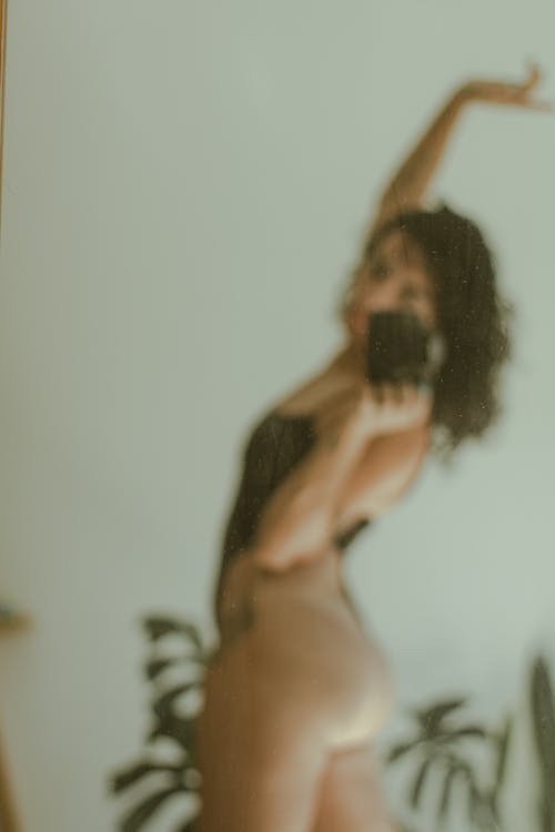 Blur Shot of Sexy Woman Photographing in Mirror