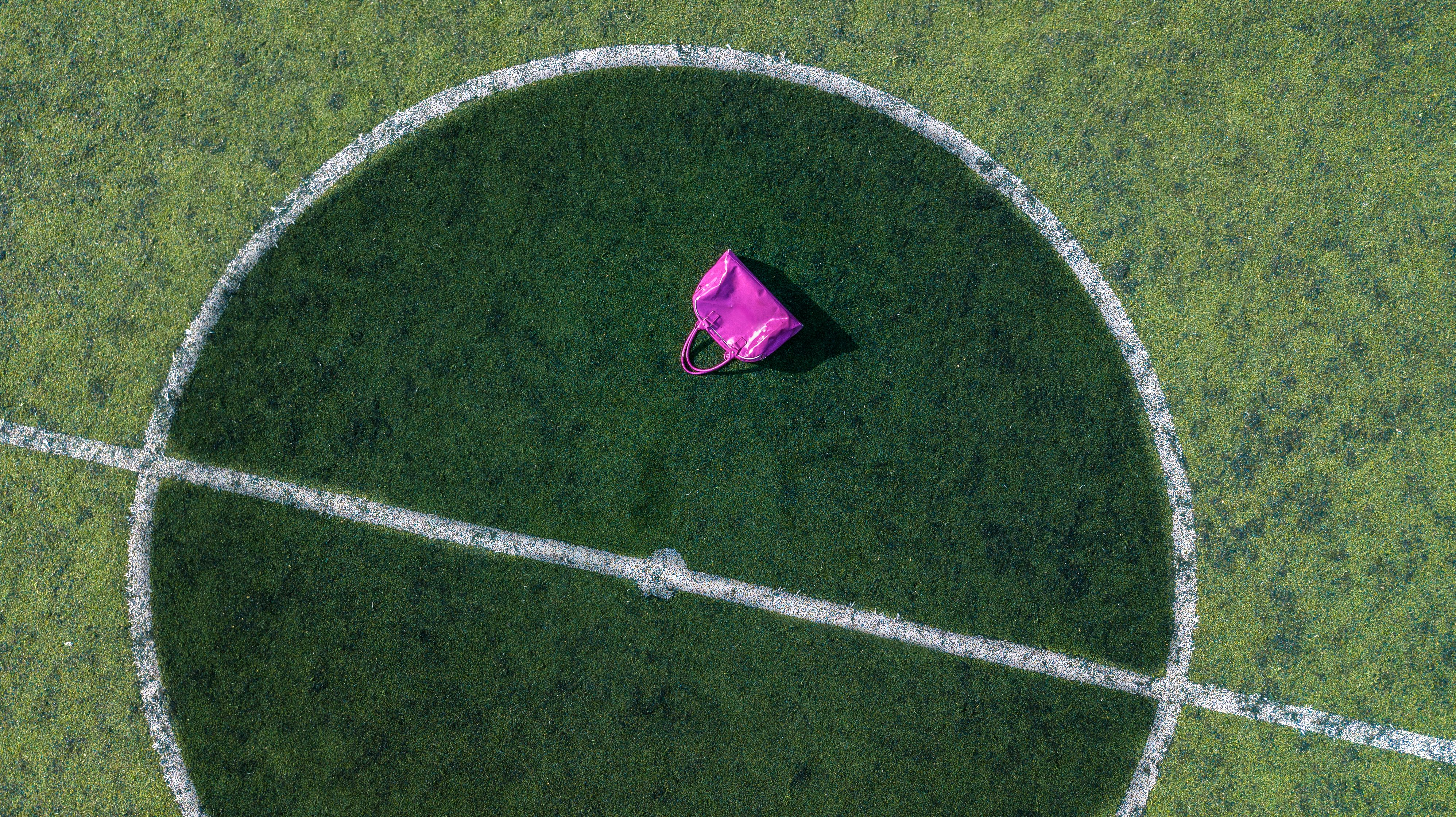 Pink Tote Bag On Football Field · Free Stock Photo